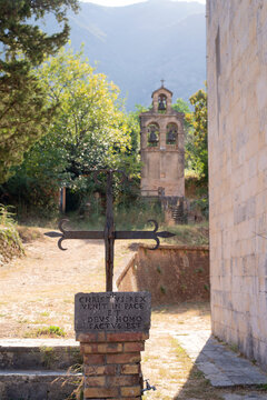 Cross and bell tower near the Church of the Assumption in Prcanj on the Bay of Kotor coast in Montenegro