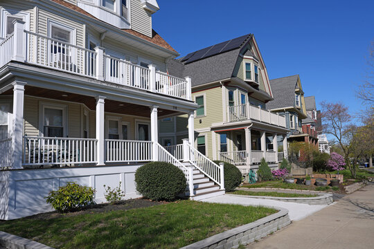 street of clapboard houses with gable and large front porch