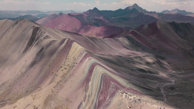 Drone aerial view of Vinicunca, also known as Rainbow Mountain, in the Peruvian Andes near Cusco. The mountain&rsquo;s colorful mineral-rich slopes create a spectacular natural landscape surrounded by high-
