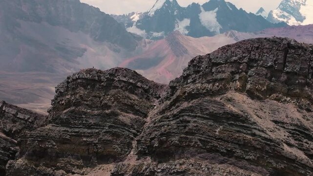 Drone aerial view of Vinicunca, also known as Rainbow Mountain, in the Peruvian Andes near Cusco. The mountain&rsquo;s colorful mineral-rich slopes create a spectacular natural landscape surrounded by high-