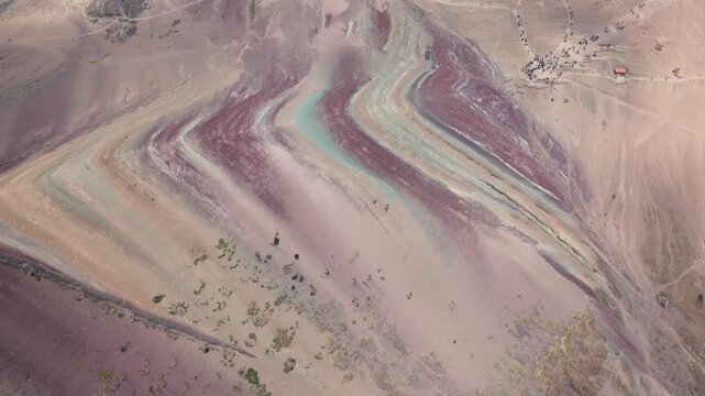 Drone aerial view of Vinicunca, also known as Rainbow Mountain, in the Peruvian Andes near Cusco. The mountain&rsquo;s colorful mineral-rich slopes create a spectacular natural landscape surrounded by high-