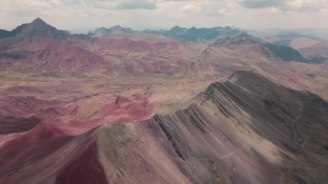 Drone aerial view of Vinicunca, also known as Rainbow Mountain, in the Peruvian Andes near Cusco. The mountain&rsquo;s colorful mineral-rich slopes create a spectacular natural landscape surrounded by high-