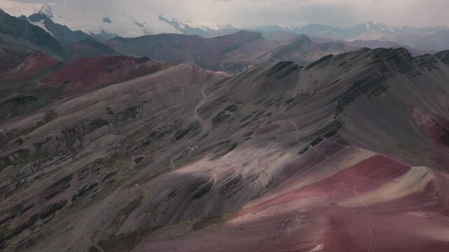 Drone aerial view of Vinicunca, also known as Rainbow Mountain, in the Peruvian Andes near Cusco. The mountain&rsquo;s colorful mineral-rich slopes create a spectacular natural landscape surrounded by high-