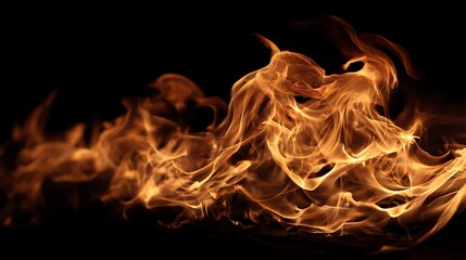 Fototapeta premium Close-up of dancing flames with an orange and yellow glow against a stark black background