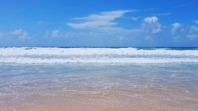 A cinematic beach surf video showing powerful ocean waves rolling and crashing onto the shore. The scene captures the beauty and energy of the sea, with dynamic surf motion, foamy water, 