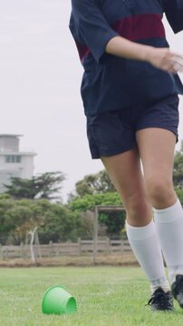 Rugby ball, woman and player on field with kick, start game and match in competition. Sport, person and football on tee for challenge, score conversion and accuracy practice with fitness on grass