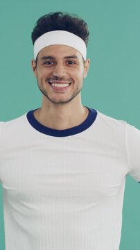 Fashion, face or man with sportswear, retro outfit or throwback aesthetic in fitness apparel. Smile, portrait or person with confidence, workout attire or vintage activewear on studio background.