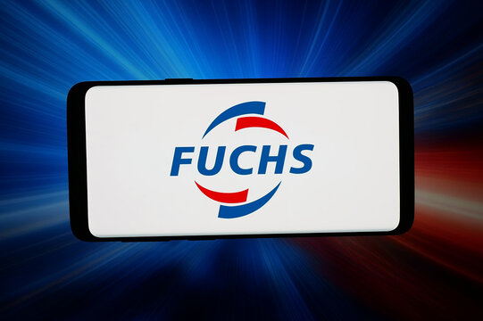 Stuttgart, Germany - 05-08-2026: In this photo illustration, the logo of German lubricants company Fuchs SE is displayed on a smartphone in front of abstract background on computer screen.