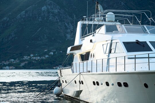 Yachts parked at marina with mountain backdrop