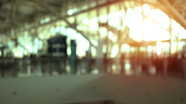 Blurred airport terminal with passengers walking and modern architecture creating an abstract and dynamic atmosphere