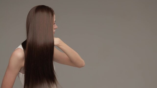 Brunette Woman Styling Long Straight Hair in Motion