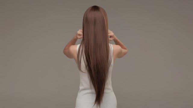 Back view of woman showing long thick and shiny brunette hair texture