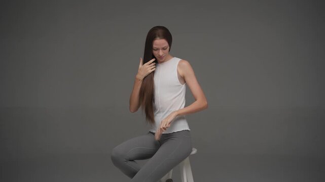 Front view of female model presenting perfect straight hair in studio
