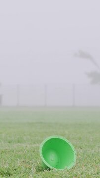 Rugby ball, foot and player on field with kick, start game or winter match in competition. Sport, person and football on tee for challenge, score conversion or accuracy practice with fitness on grass