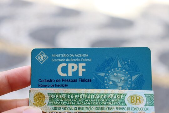 Salvador, Brazil - May 13, 2026: Person holding a Brazilian CPF card and Driver's License (CNH). Concept of identity verification. CPF and CNH. 