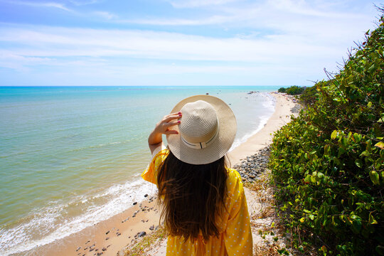 Holidays in Joao Pessoa, Brazil. Young woman looking at Ponta do Seixas in Joao Pessoa, the easternmost point of the American continent.