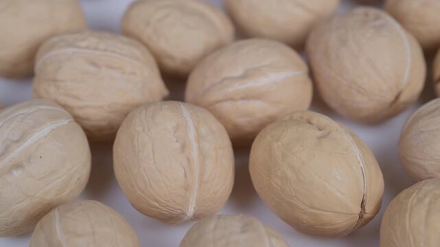 Detailed view of walnuts. Closeup of whole and shelled walnuts showing surface details. Highresolution macro image capturing textured shells and natural grain of walnuts