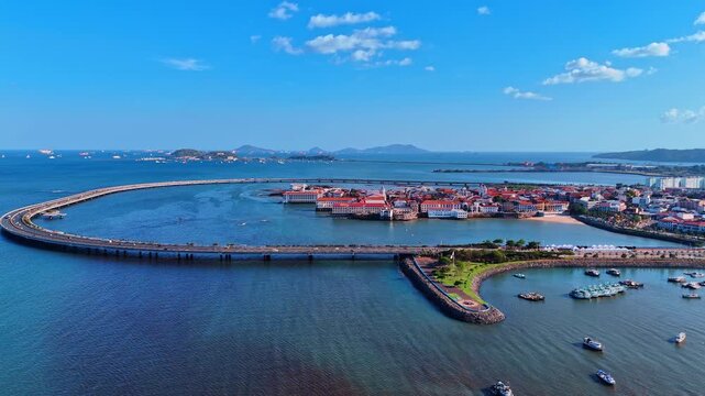 Casco Viejo peninsula and coastal highway aerial view. Aerial view of Casco Viejo, coastal highway, bay water, red roofs, islands and ships in background