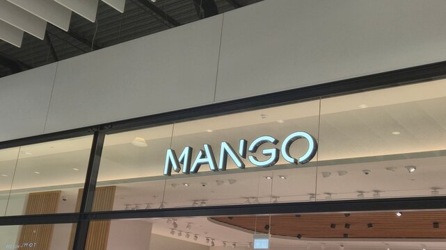 Vilnius Lithuania 09.05.2026 Mango fashion store illuminated logo on modern shopping mall facade with elegant retail design contemporary architecture and stylish commercial atmosphere indoors