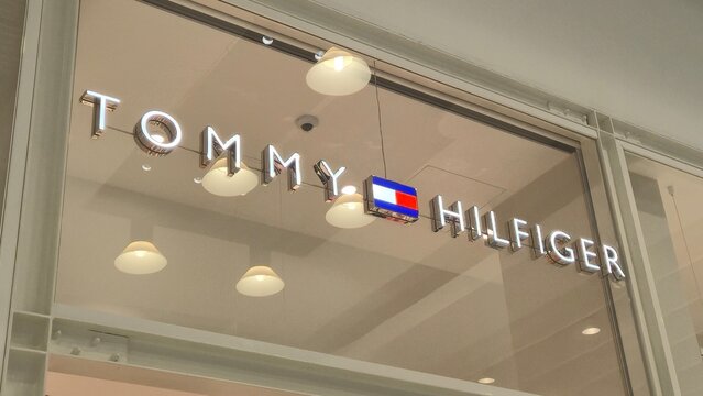 Vilnius Lithuania 09.05.2026 Tommy Hilfiger illuminated fashion store logo on modern shopping mall facade with premium retail branding elegant commercial interior and contemporary lifestyle atmosphere