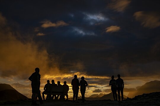 People marvelling at Montafon mountains with dramatic cloudy sky at sunset, Tschagguns, R&auml;tikon, Montafon, Vorarlberg, Austria
