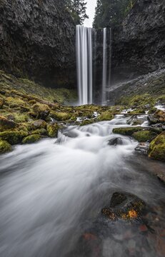 Waterfall flows over rocky outcrop, long term exposure, River Cold Spring Creek, Tamanawas Falls, Oregon, USA