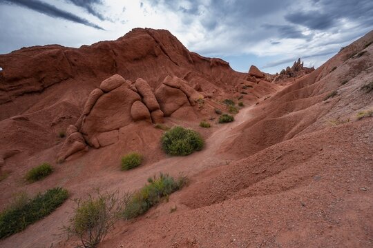 Canyon of eroded sandstone formations, red and orange sandstone rocks, fairytale gorge, Skazka, Tosor, Kyrgyzstan