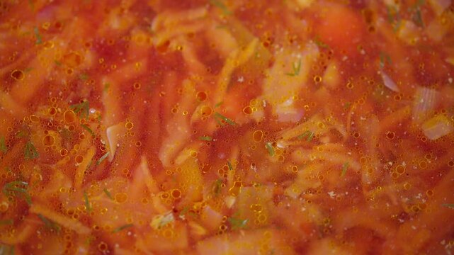 Homestyle hot beet vegetable soup. Hearty red beet and vegetable stew simmering. Warm and rustic scene of homemade borscht filled with colorful vegetables and tender meat