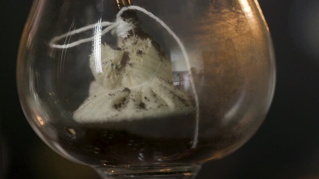 adding ground coffee to a vintage siphon coffee maker