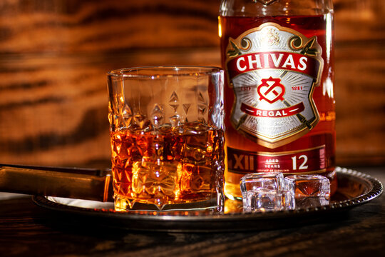 Chivas Regal Scotch Whisky Bottle With Crystal Whiskey Glass And Ice Cubes