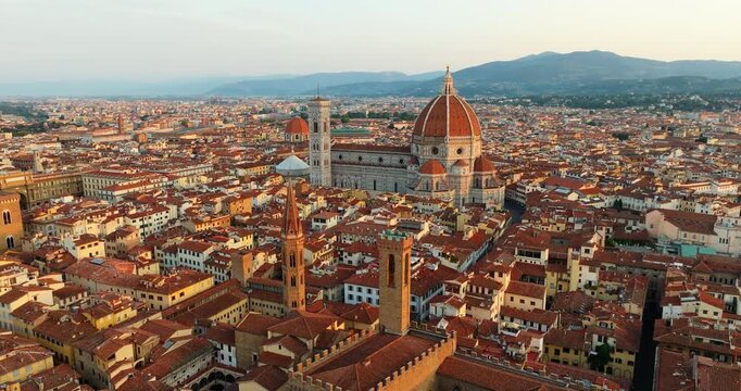 Florence aerial cityscape Palazzo Vecchio tower center Tuscany Italy terracotta rooftops drone dusk Renaissance urban panorama travel landmark slow motion Firenze historic wide overview tourism