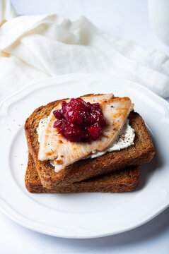 Open Sandwich with leftover turkey slices with cranberry sauce on top. Perfect holiday breakfast or lunch