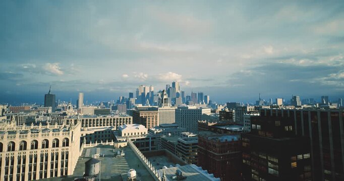 distant metropolis visible beyond layered rooftop composition, cold midday light, textured brick foreground, subdued cloudscape, urban scale and rhythm