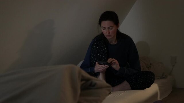 Woman using phone at night