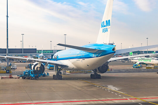 Amsterdam, Netherlands - 22.01.2026: Klm asia boeing 777 aircraft parked at schiphol airport with ground handling support vehicles in amsterdam