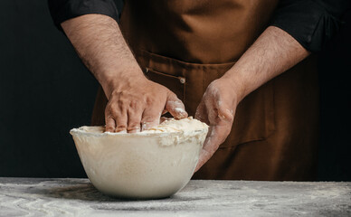 Fototapeta premium Professional baker kneading sourdough dough in glass bowl for artisan bakery advertising