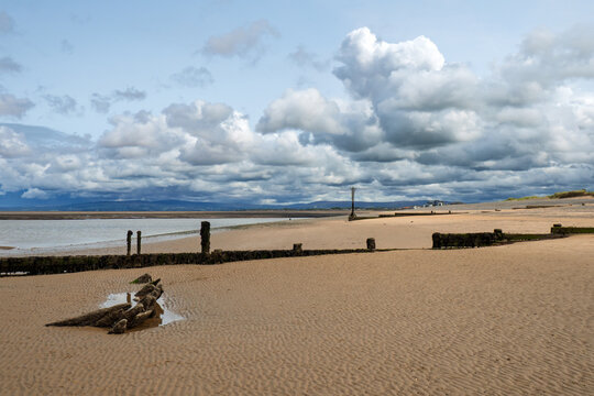 Remains of an old wooden boat buried in the sand on the beach at Fleetwood in Lancashire