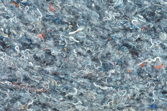 Colored felt fabric as background, top view. Natural felt texture. Colorful texture of a polyamide pillow. Recycled insulation material.