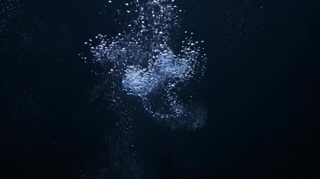 Glowing water splash in dark blue space