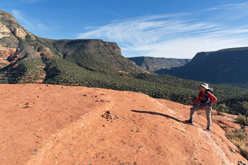 Fototapeta premium Woman Hiking On Steamboat Rock Deck Near Sedona Arizona