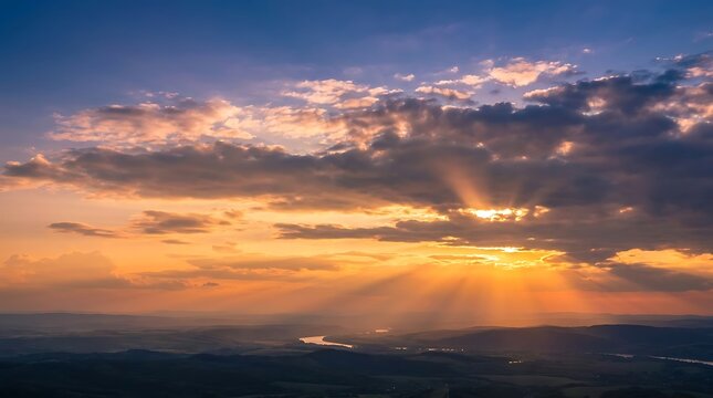 World environment day Dramatic sunset with sunbeams breaking through clouds over rolling hills and a river rays