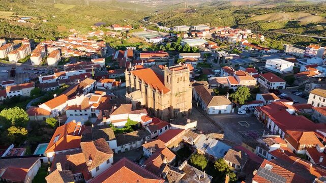 Aerial view of Basilica Menor de Nossa Senhora da Assuncao and red-tiled rooftops in the historic center of Torre de Moncorvo, Braganca, Portugal.
