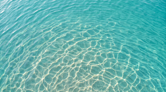 Gentle turquoise water ripple pattern with sunlight creating sparkling reflections on the surface
