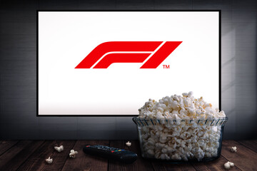 Fototapeta premium Cali, Colombia - May 13 2026: Popcorn and TV displaying Formula One logo screen