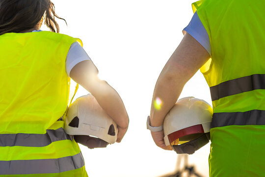 Engineering team walking with hard hats, working with renewable energy technology