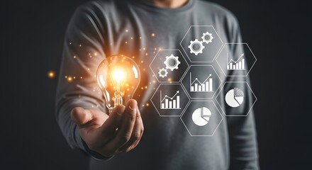 Fototapeta premium Innovation concept hand holding glowing lightbulb with business data graphics