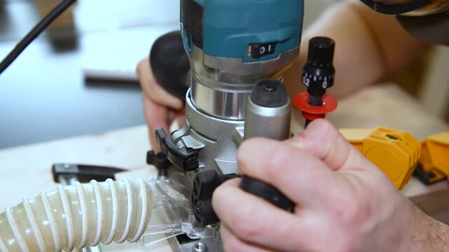 Wood router in action cutting into a wooden surface. The spinning bit carves a precise groove as the tool is guided smoothly across the material.