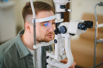 Man receiving eye exam with a slit lamp © Serhii
