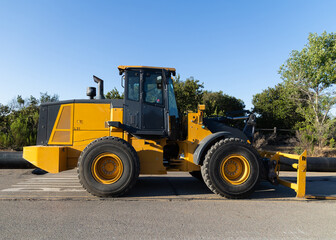 Fototapeta premium John Deere Tractor modern equipment in construction site, side view