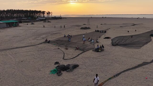Fishermen Repairing Fishing Nets at Sunset on Cox&rsquo;s Bazar Beach Bangladesh